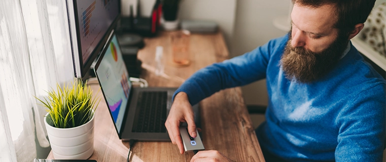 Man backing up computer data on hard drive