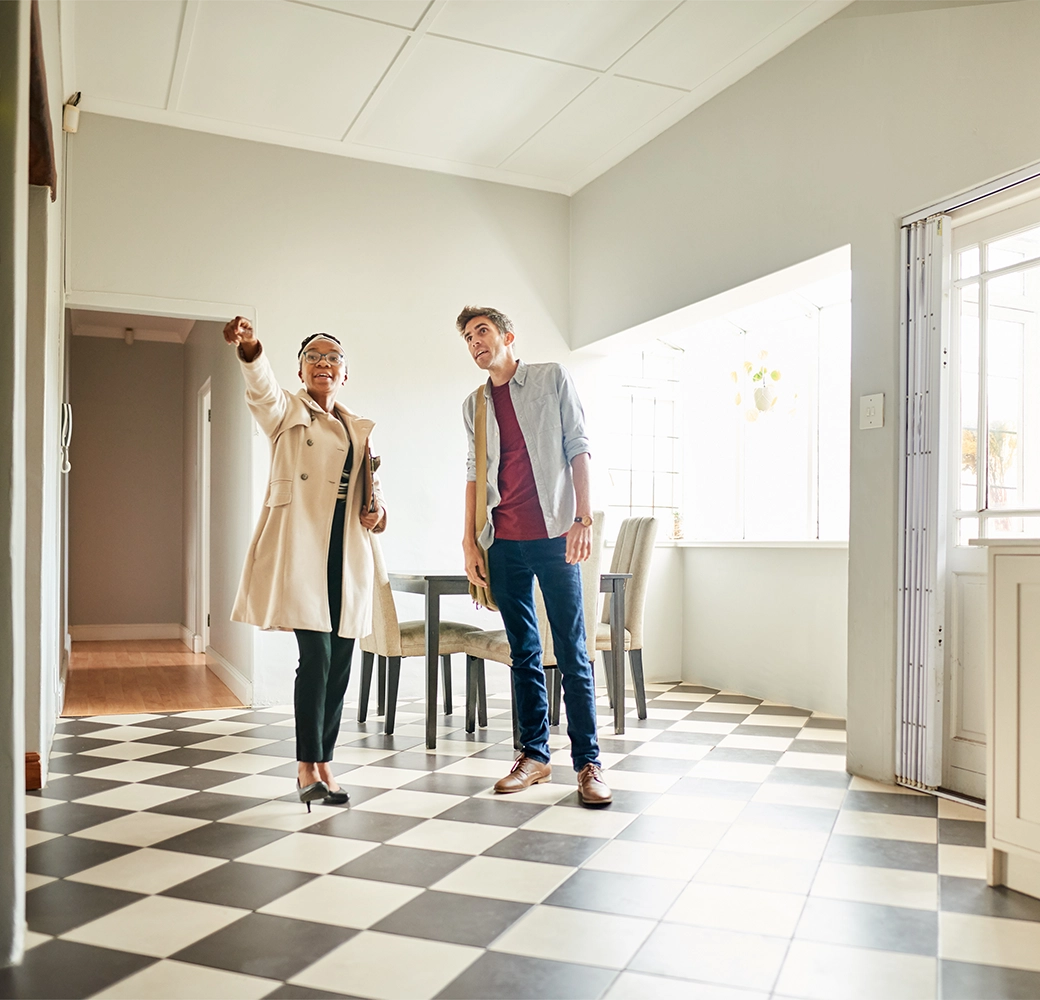 Female real estate agent and male inspecting house